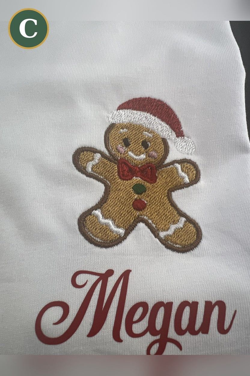 Option C: embroidered gingerbread man logo with the printed name Megan on a white tee